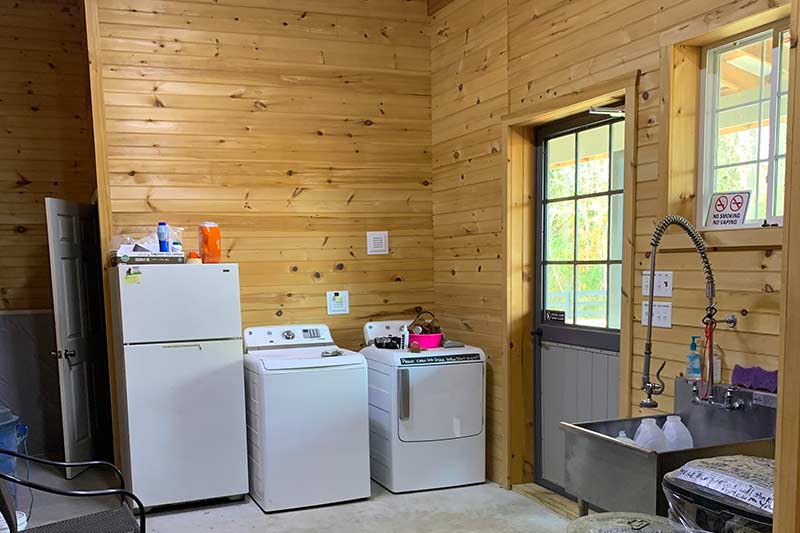 Utility room with washer, dryer and refrigerator.